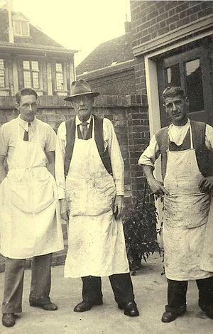 The original workshop owners: Charles Winlove and his two sons standing at the back of the building in the 1940s