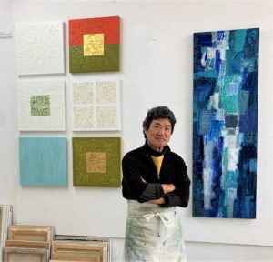 Portait of Isao Miura with Rice Paddy paintings behind him