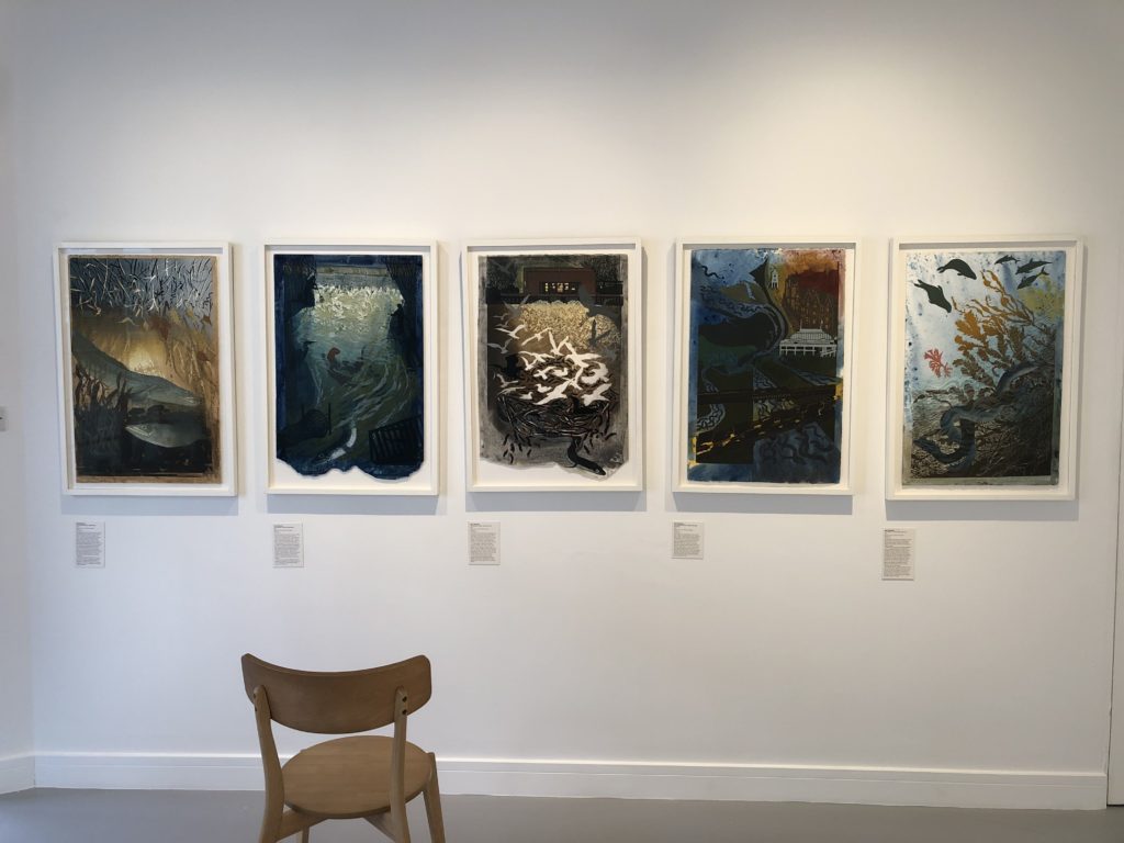 Front facing view of five Julia Manning prints. With a chair in front.