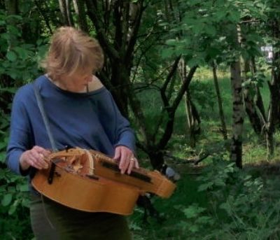 Sensing Trees: Stevie Wishart playing hurdy gurdy in a forest